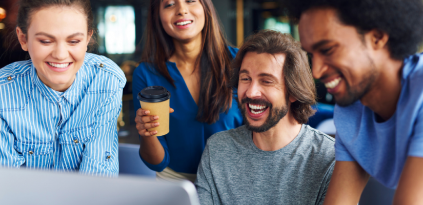 Diverse team looking at laptop