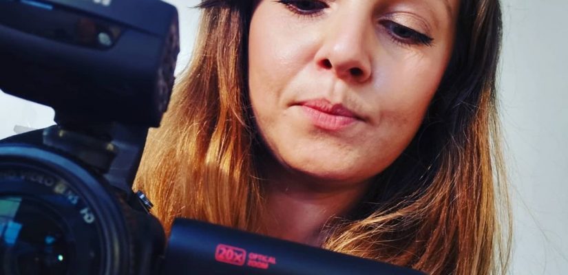 Rachel behind canon video camera filming