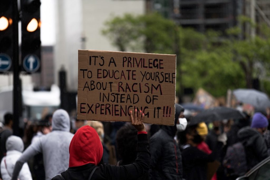 Sign saying 'It's a privilege to educate yourself about racism instead of experiencing it!!'
